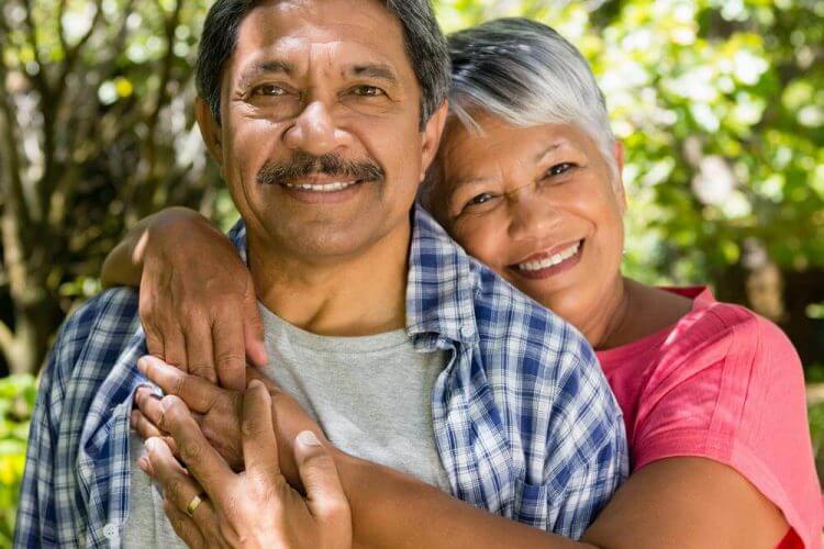 Smiling couple embracing outside