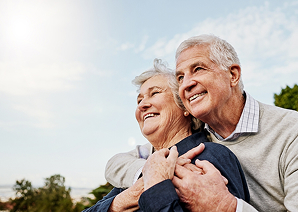 Older couple smiling outdoors
