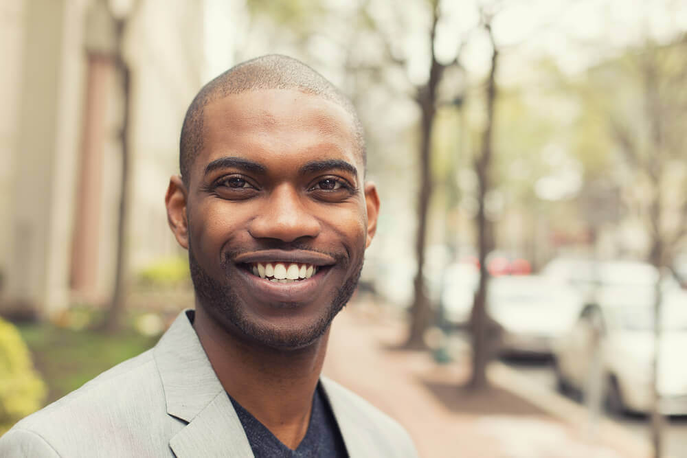 Smiling young man outside