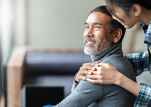Man smiling with someone behind him