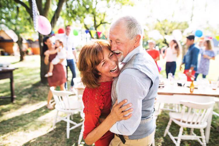 Smiling man and woman dancing at a party