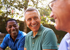 Man smiling with someone behind him