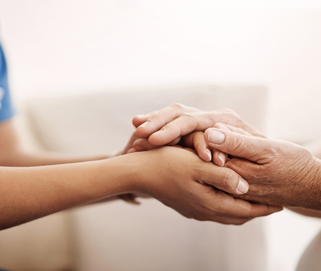 Hands holding in a caring gesture